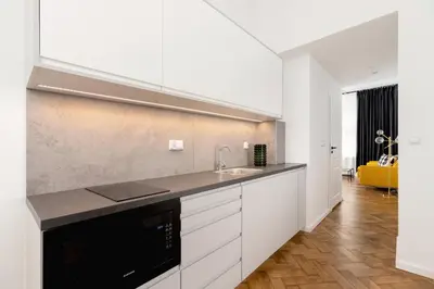 a kitchen with white cabinets and a sink at Main Square - Modern Apartment - 7 Gertrudy street in Kraków