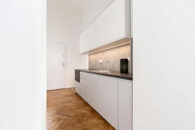 a kitchen with white cabinets and a sink at Main Square - Modern Apartment - 7 Gertrudy street in Kraków