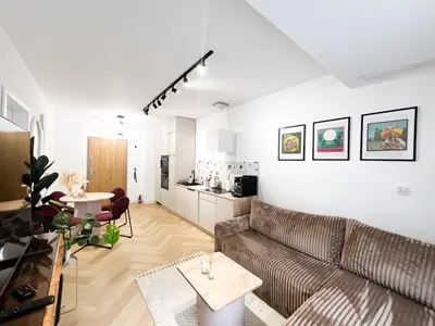 a living room with a couch and a table at Charming Apartment in a green area- free parking in Kraków