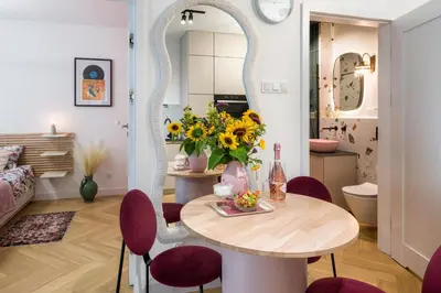 a dining room with a table and chairs and a mirror at Charming Apartment in a green area- free parking in Kraków