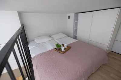 a bedroom with a bed with a tray with a plant on it at Studio z Klimatyzacją na Krakowskim Kazimierzu by Noclegi Renters in Kraków