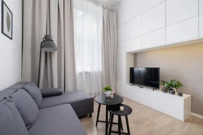 a living room with a couch and a tv at Studio z Klimatyzacją na Krakowskim Kazimierzu by Noclegi Renters in Kraków