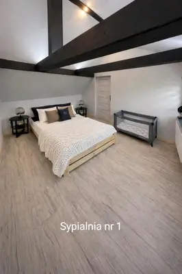 a bedroom with a large bed in a room at Dom u Teresy in Harkabuz
