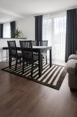 a dining room table and chairs in a living room at Dom u Teresy in Harkabuz