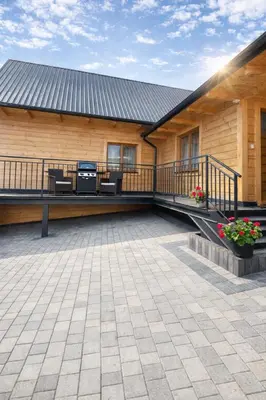 a building with a deck with chairs and a grill at Dom u Teresy in Harkabuz