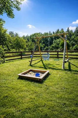 a park with a swing set in the grass at Dom u Teresy in Harkabuz