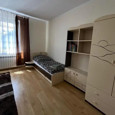 a bedroom with a bed and a book shelf at Pogodny Dom in Włosienica