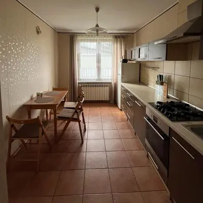 a kitchen with a table and a dining room at Pogodny Dom in Włosienica