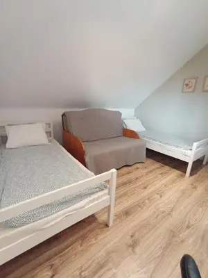 a small room with two beds and a couch at Blisko Energylandii in Zator