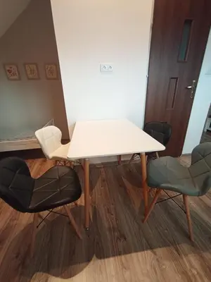 a white table and two chairs in a room at Blisko Energylandii in Zator