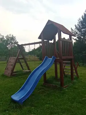 a playground with a blue slide and a swing at Blisko Energylandii in Zator