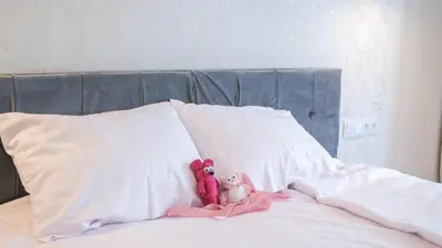 two stuffed animals sitting on top of a bed at Luxury apartment Free parking - by Hosty in Kraków