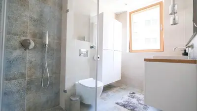 a bathroom with a shower and a toilet and a sink at Luxury apartment Free parking - by Hosty in Kraków