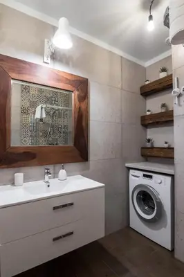 a bathroom with a sink and a washing machine at 2-Bedroom Apartment - Sarego 16 in Kraków