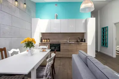 a kitchen and dining room with a white table and chairs at 2-Bedroom Apartment - Sarego 16 in Kraków