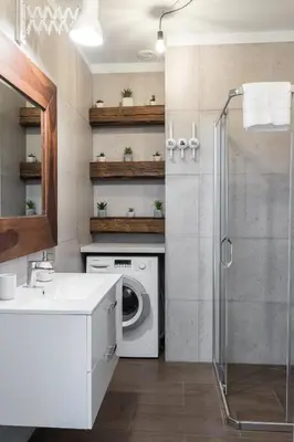 a bathroom with a washing machine and a sink at 2-Bedroom Apartment - Sarego 16 in Kraków
