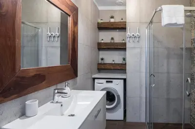 a bathroom with a sink and a washing machine at 2-Bedroom Apartment - Sarego 16 in Kraków