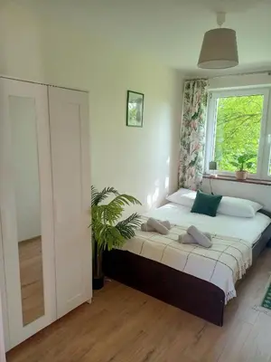 a bedroom with a large bed with a window at Gawlasoowka in Inwałd