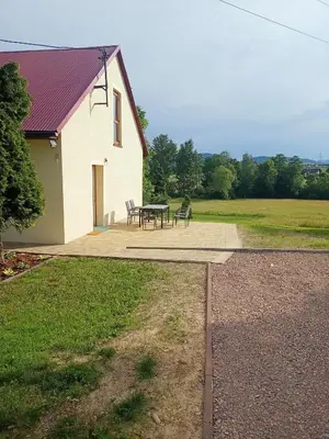 a picnic table and chairs in front of a building at Gawlasoowka in Inwałd