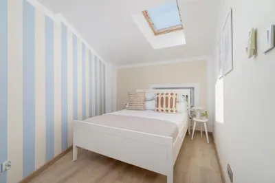 a white bedroom with a bed and a table at 3-Bedroom apartment in the centre - Old Town in Kraków