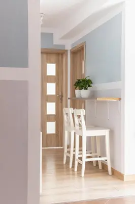 a kitchen with two white chairs and a table at 3-Bedroom apartment in the centre - Old Town in Kraków
