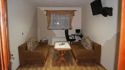 a living room with a table and two chairs at Willa Pod Dębami - SALA ZABAW - Małpi Gaj - blisko centrum in Rabka