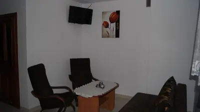 a living room with two chairs and a table at Willa Pod Dębami - SALA ZABAW - Małpi Gaj - blisko centrum in Rabka