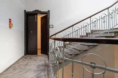 a stairway with a black door and a stair case at Two-bedroom apartment - Old Town in Kraków