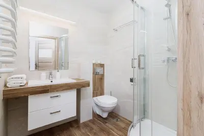 a bathroom with a toilet sink and a shower at Two-bedroom apartment - Old Town in Kraków
