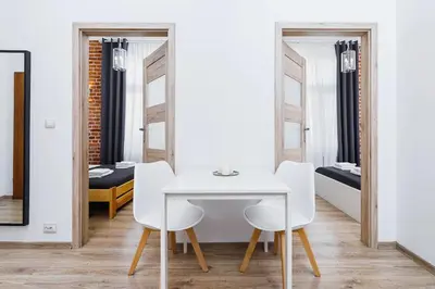 a white table and chairs in a room with mirrors at Two-bedroom apartment - Old Town in Kraków