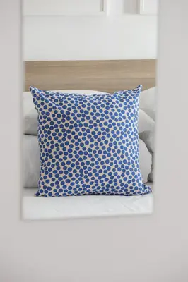 a blue pillow sitting on top of a bed at Entire apartment in Kraków, Poland in Kraków