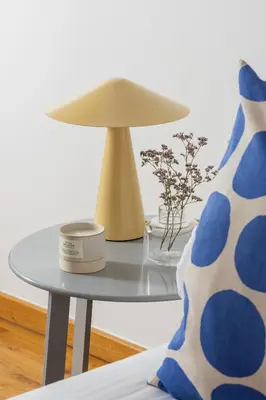 a table with a lamp and a vase on it at Entire apartment in Kraków, Poland in Kraków