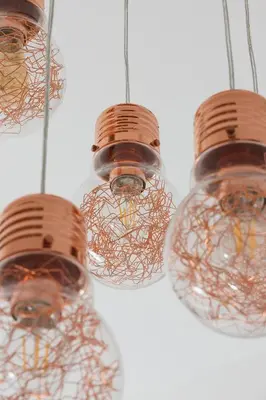 three lights are hanging from a ceiling at Entire apartment in Kraków, Poland in Kraków