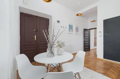 a white dining room with a white table and white chairs at Entire apartment in Kraków, Poland in Kraków