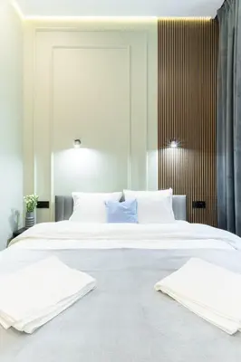 a bedroom with a large white bed with two pillows at Charm & Comfort Renovated Gem in Old Town Sarego apt B in Kraków