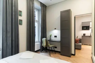 a bedroom with a bed and a desk and a mirror at Charm & Comfort Renovated Gem in Old Town Sarego apt B in Kraków