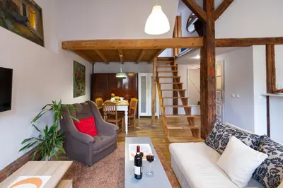a living room with a couch and a table at Sky's the limit! Spacey loft in Kraków