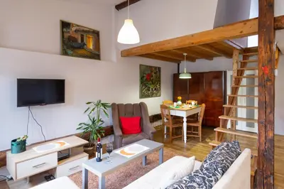 a living room with a table and a couch at Sky's the limit! Spacey loft in Kraków