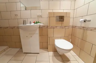 a bathroom with a toilet and a sink at Place 4 You Apartments in Kraków