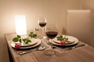 a table with two glasses of wine on a table at Place 4 You Apartments in Kraków