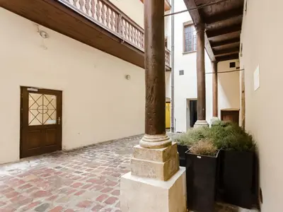 a column in the middle of a courtyard with a door at Place 4 You Apartments in Kraków