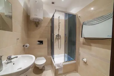 a bathroom with a sink and a toilet and a shower at Place 4 You Apartments in Kraków