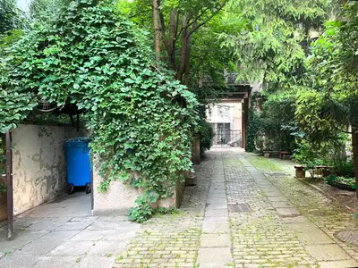 a ivy covered wall with a blue trash can at Large Apartment 2 bedrooms and living room, Kazimierz District in Kraków