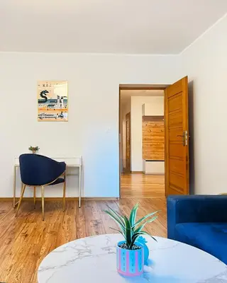 a living room with a blue couch and a table at Large Apartment 2 bedrooms and living room, Kazimierz District in Kraków