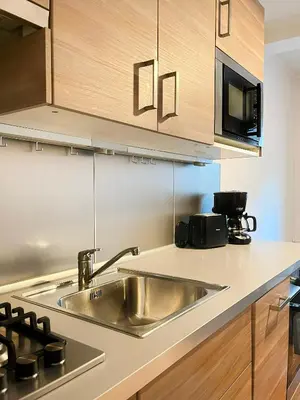 a kitchen with a sink and a microwave at Large Apartment 2 bedrooms and living room, Kazimierz District in Kraków