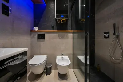 a bathroom with a toilet and a sink and a shower at RentPlanet - Apartament Kasztelańska in Kraków