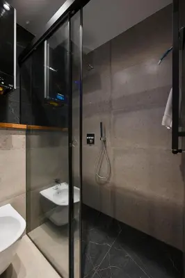 a bathroom with a sink and a toilet and a shower at RentPlanet - Apartament Kasztelańska in Kraków