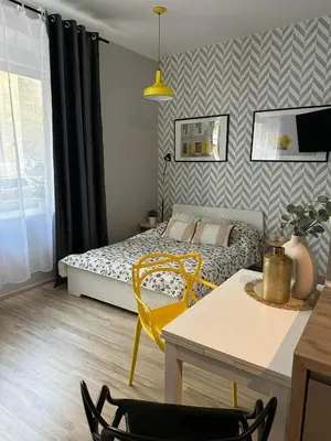 a bedroom with a bed and a table and chairs at Apartament Mazowiecka 11 in Kraków