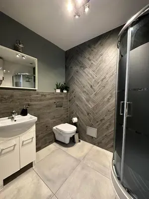 a bathroom with a toilet and a sink at Apartament Mazowiecka 11 in Kraków