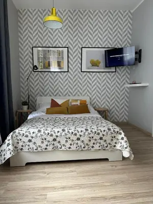 a bedroom with a bed and a wall at Apartament Mazowiecka 11 in Kraków